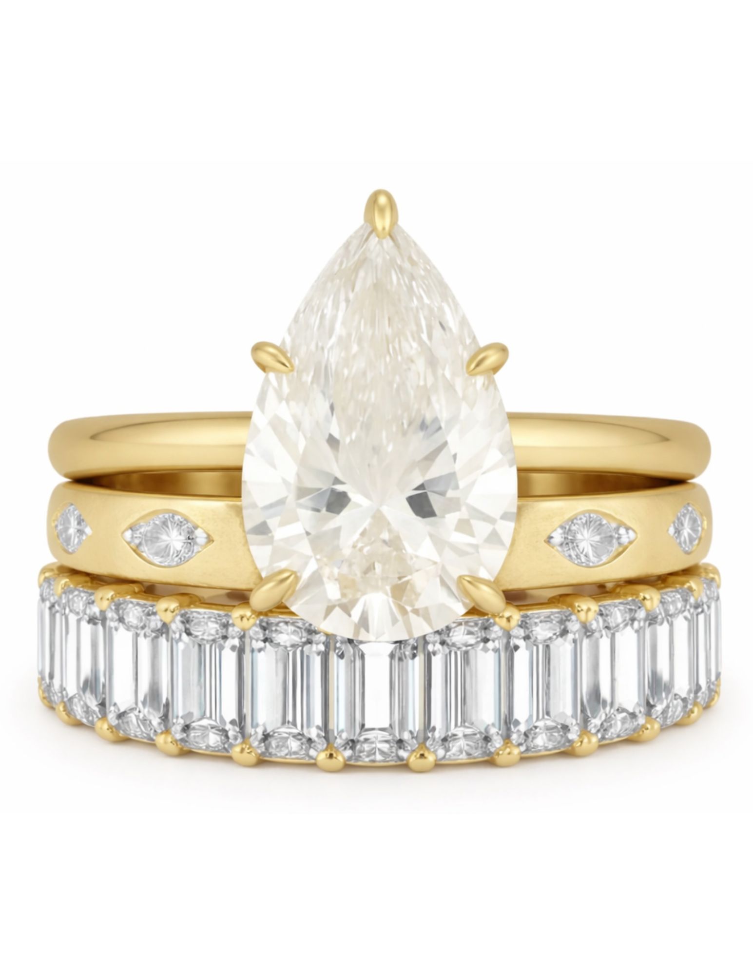 Gold ring with pear-shaped diamond and baguette-cut diamonds on a white background