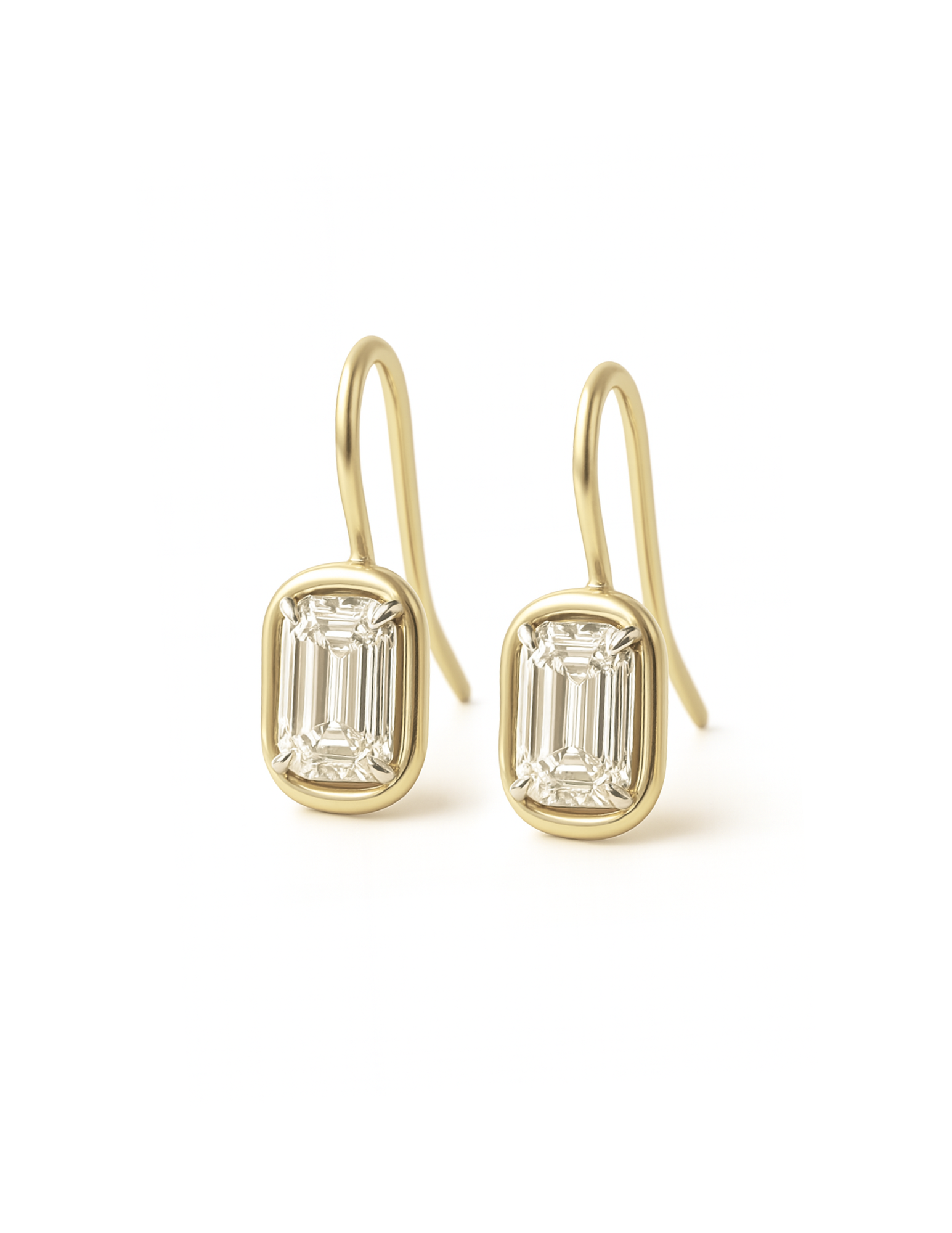 Gold earrings with emerald-cut diamond on a white background