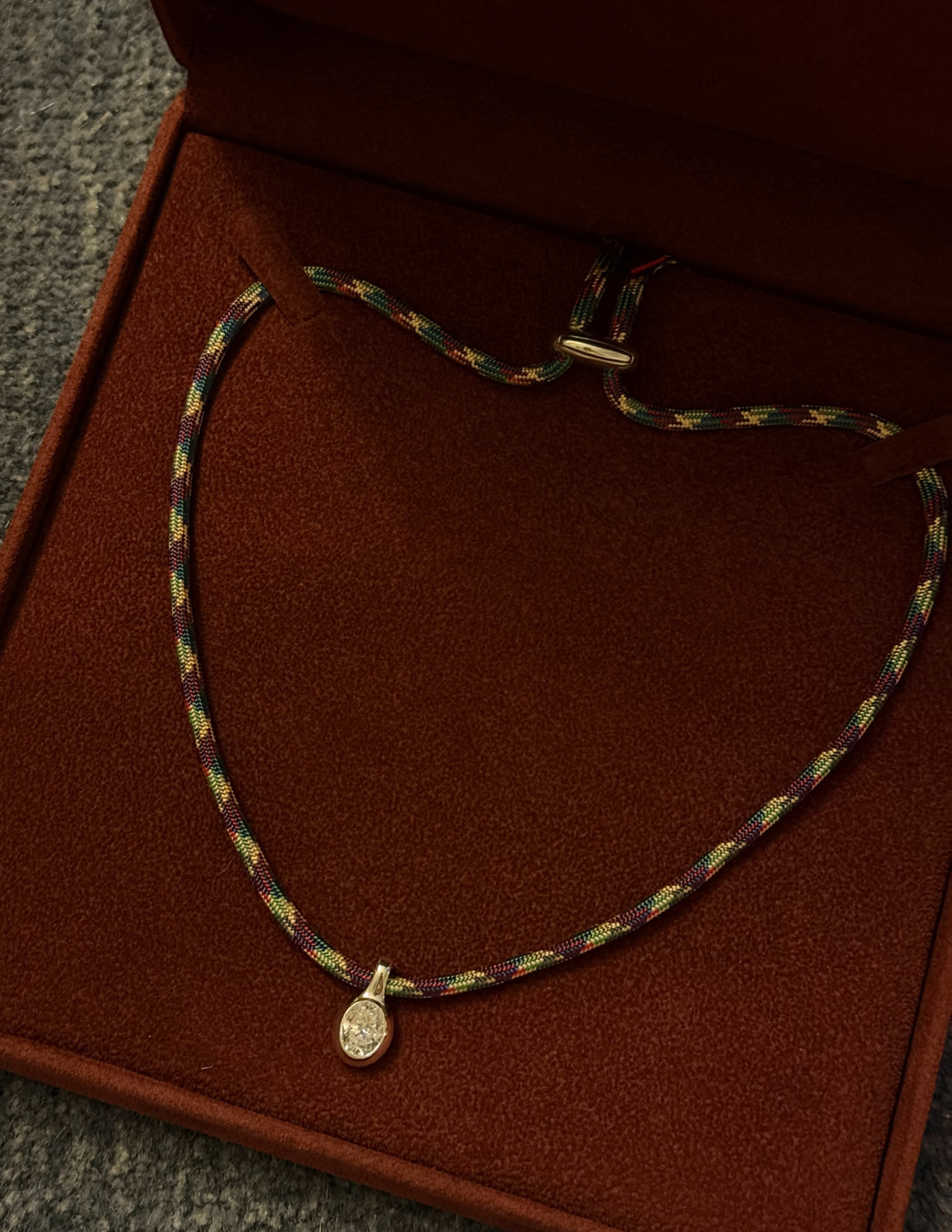 Necklace with a pendant on a brown jewelry box