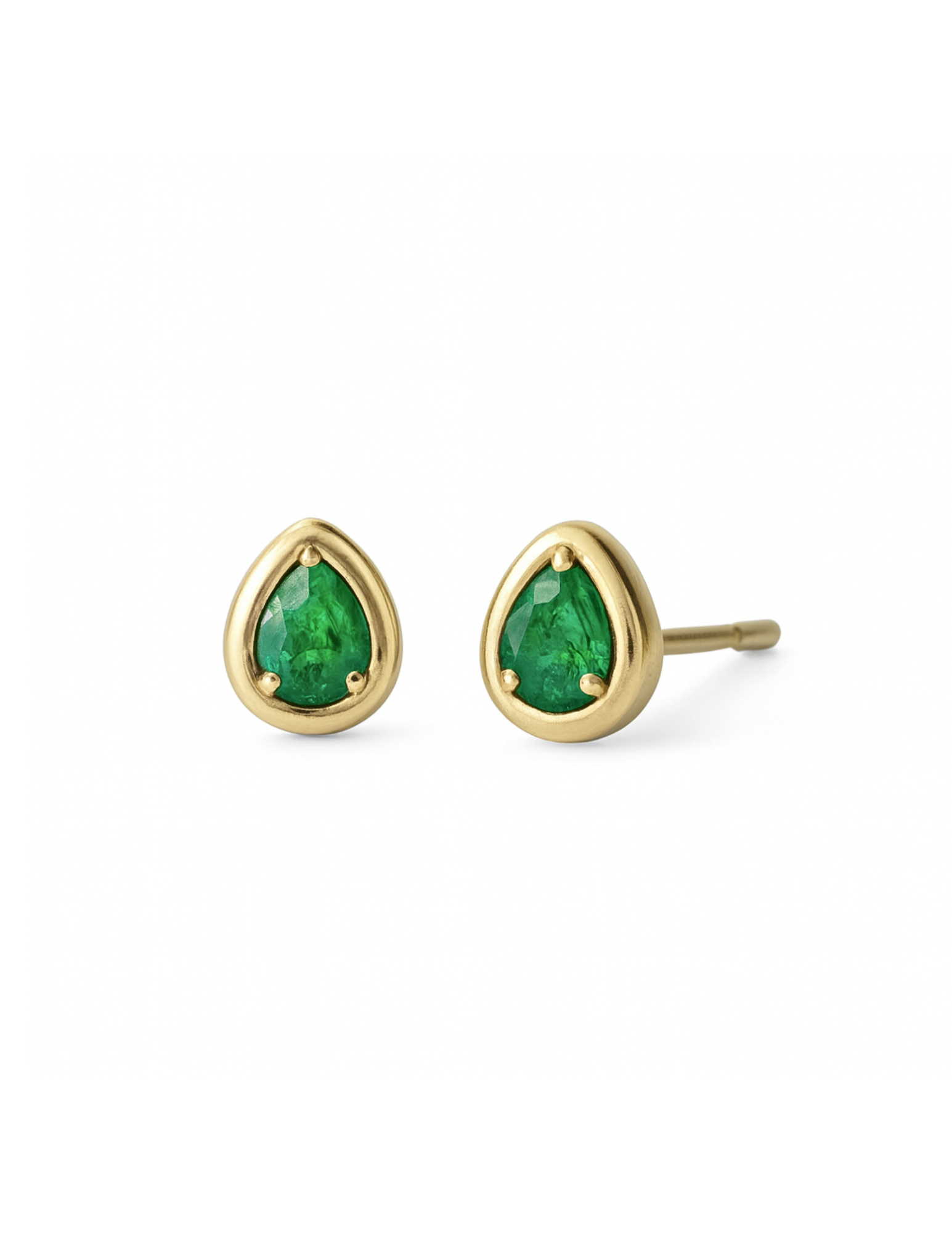 Gold earrings with green gemstones on a white background