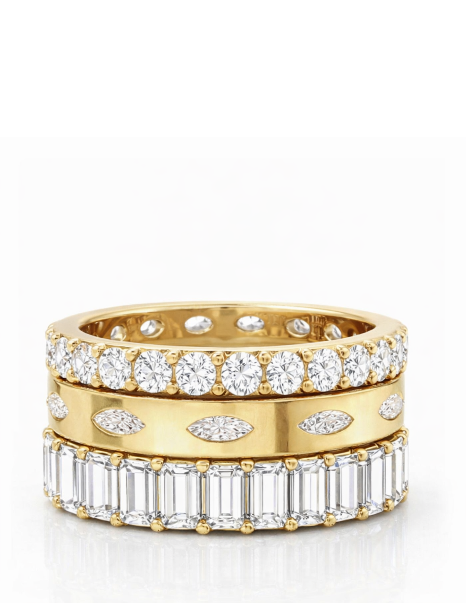 three gold and diamond rings on a white background