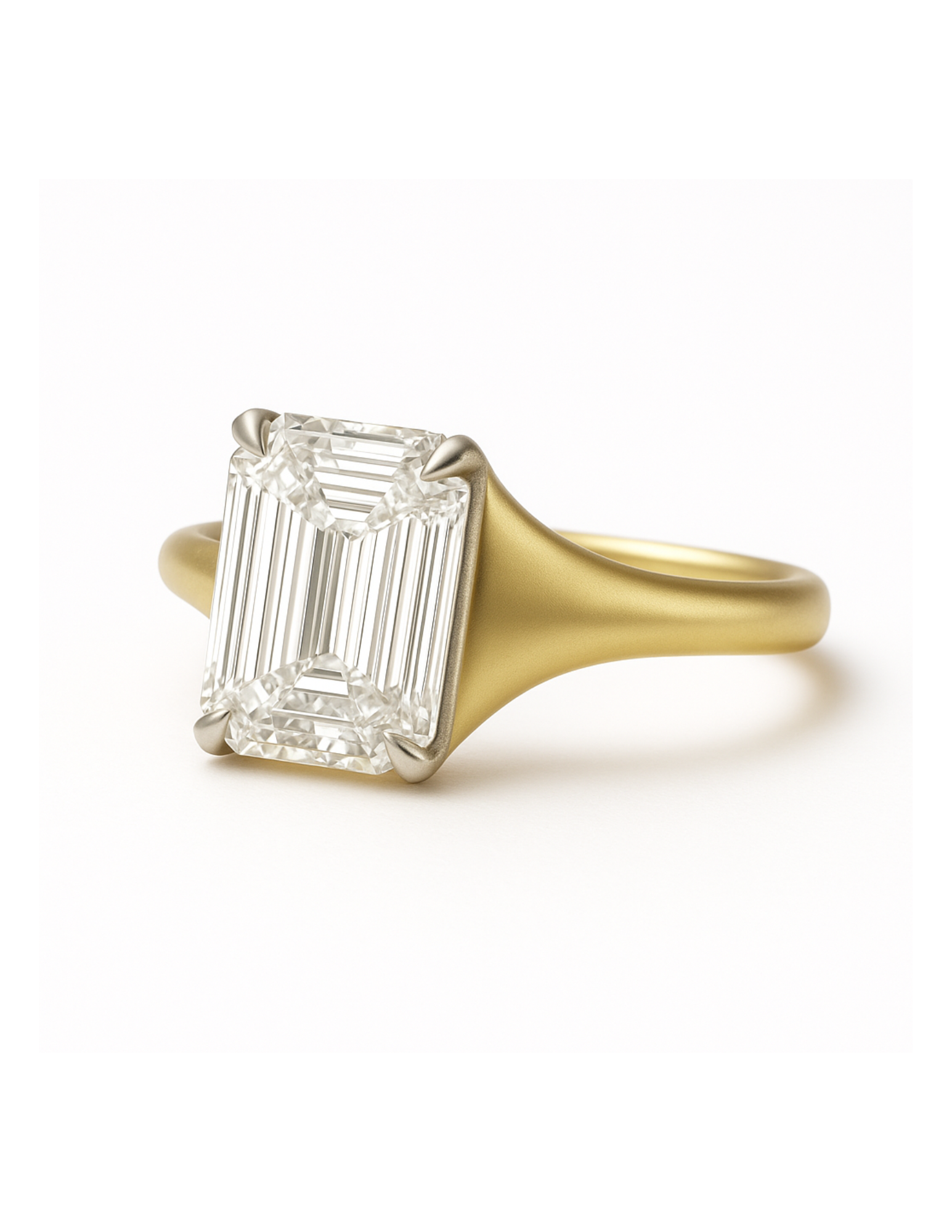 Gold ring with a large emerald diamond on a white background